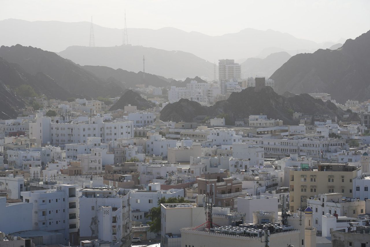 The Hazy Cityscape and Mountain Backdrop