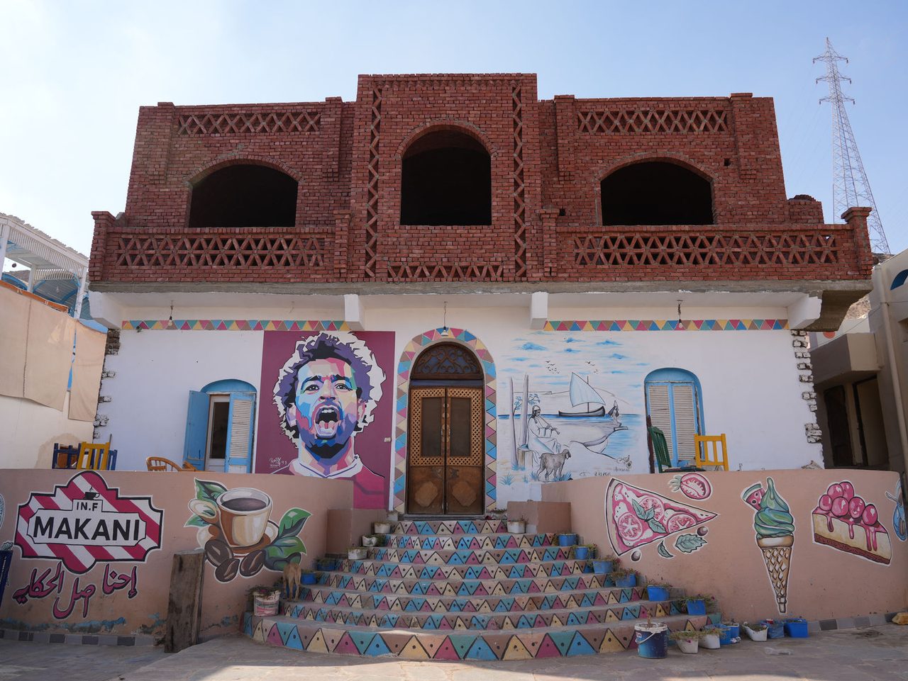 The colorful Mohamed Salah mural framing a vibrant building in the Nubian Village