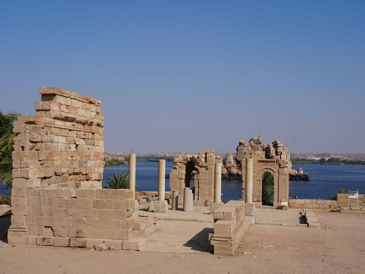 The historic stone ruins and gateways overlooking the Nile at Philae Temple