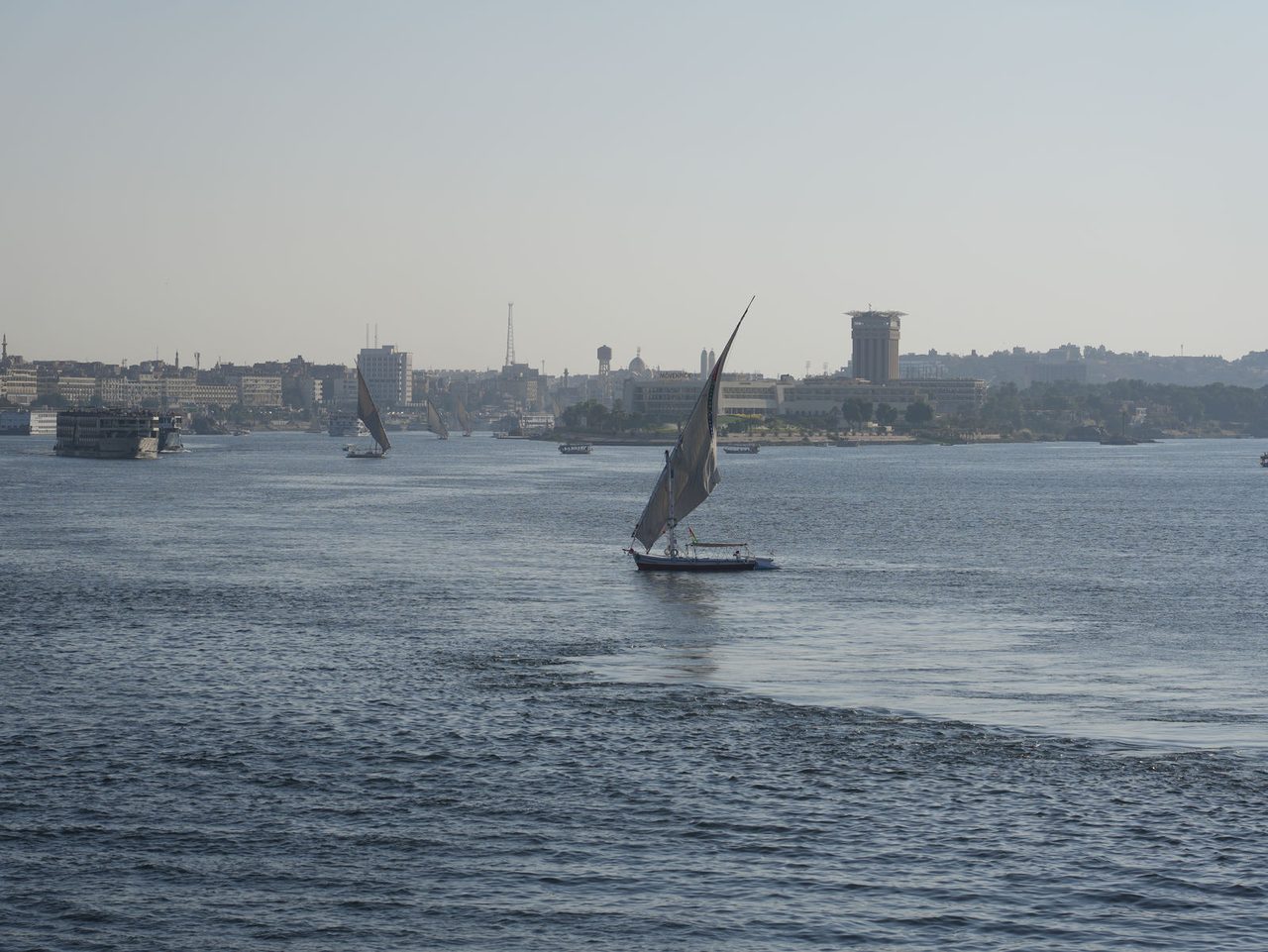 A beautiful traditional felucca spreading its sails on the wide Nile River