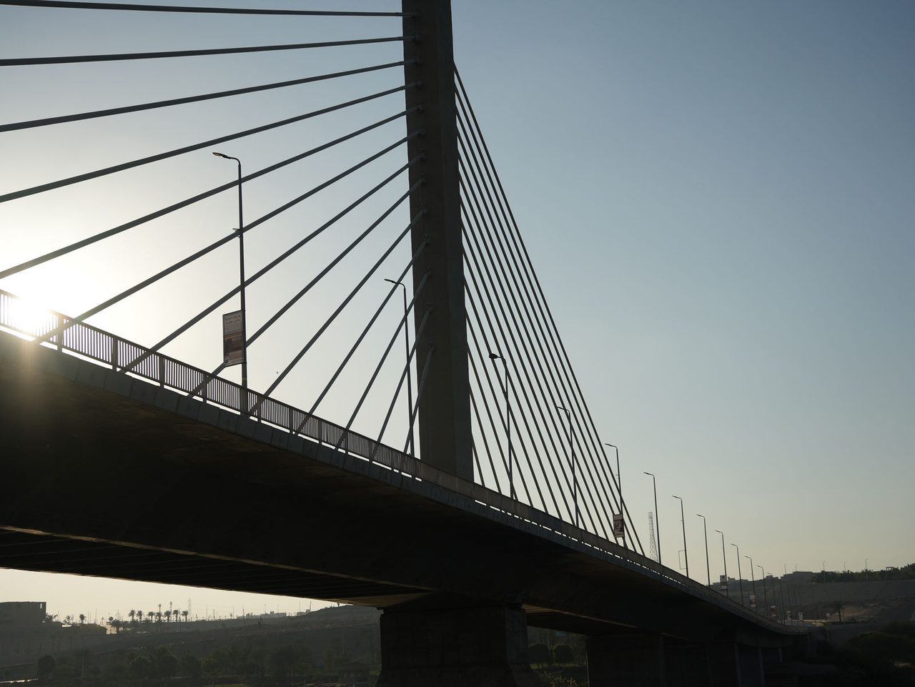 The striking geometric lines of a massive cable-stayed bridge over the Nile