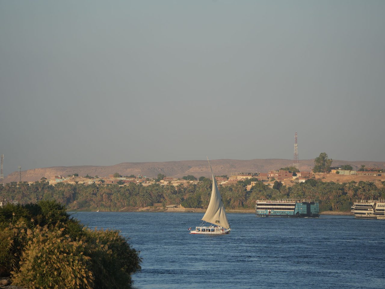 A traditional felucca catching the wind on the wide Nile River