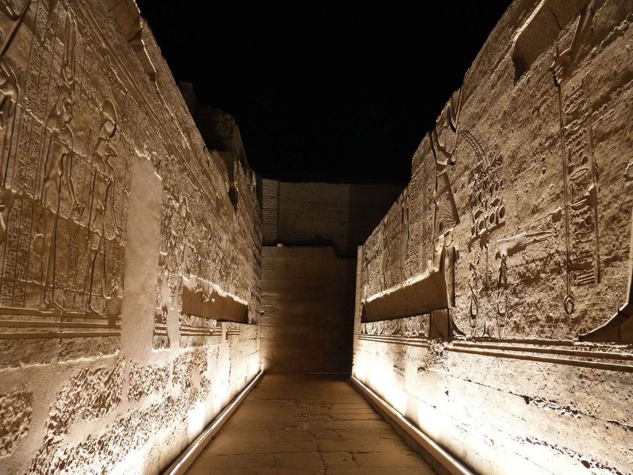 The majestic illuminated pathway deep inside the Temple of Kom Ombo