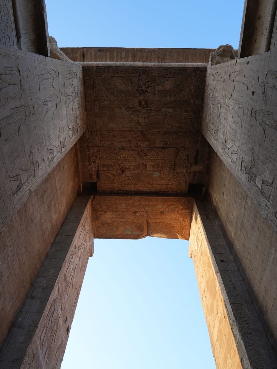 The decorated lintel and winged sun disc at the entrance of the Temple of Edfu