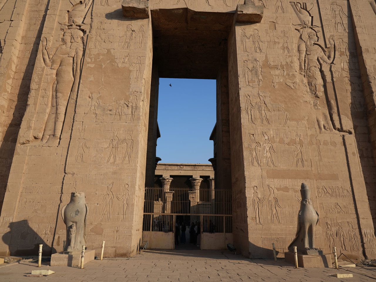 The majestic falcon statues of Horus guarding the entrance to the Temple of Edfu