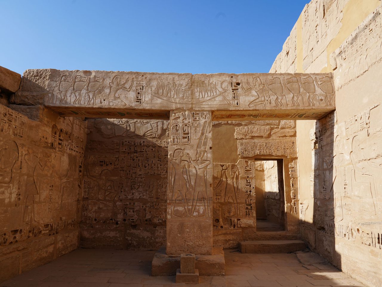 An architectural lintel and square pillar with reliefs at Medinet Habu