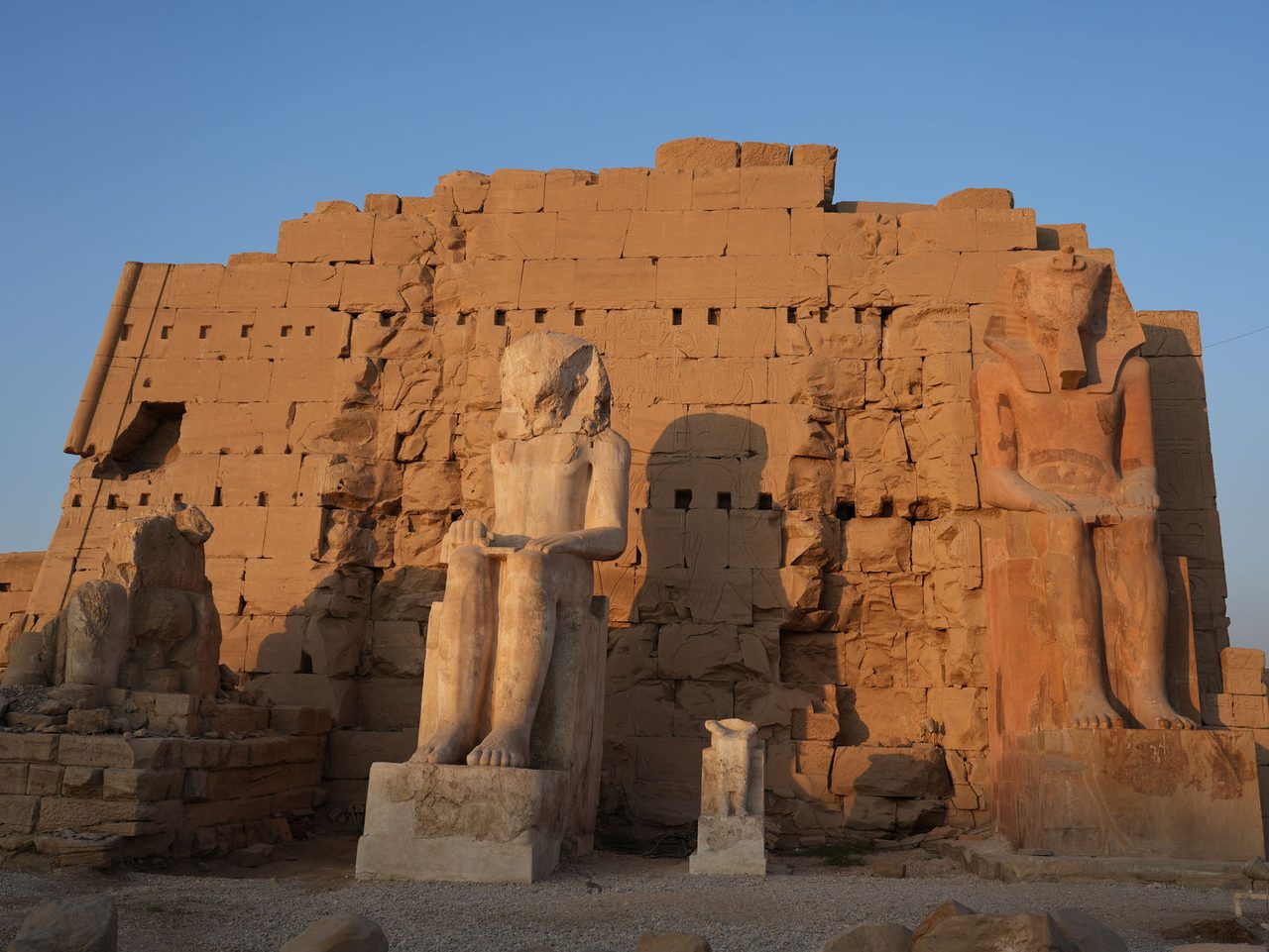 The colossal colossal seated statues of Ramesses II in front of the pylon at Karnak Temple