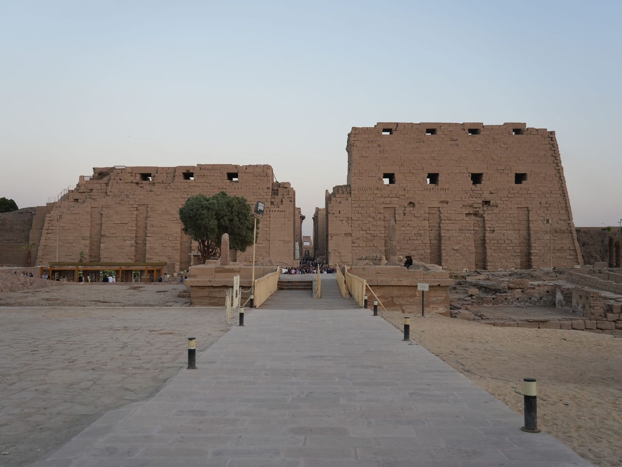 The panoramic view of the monumental first pylon and entrance pathway at Karnak Temple