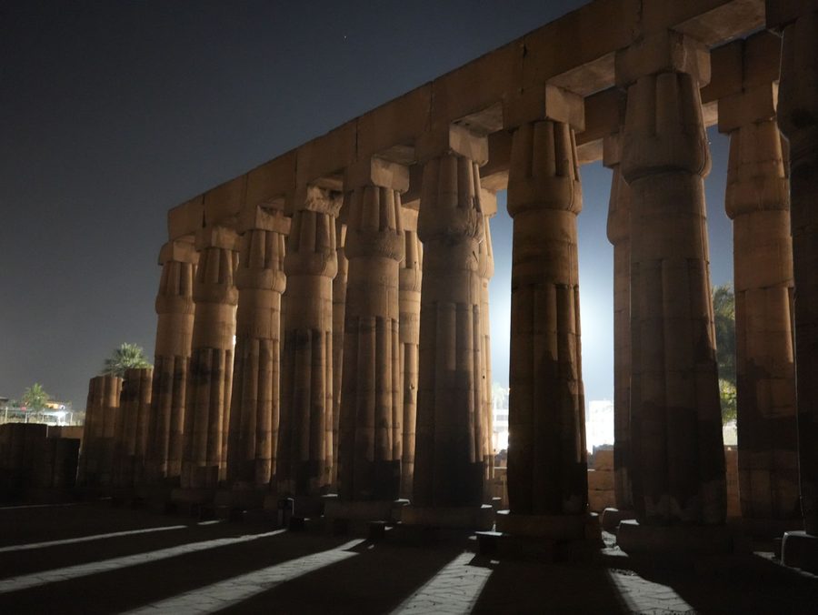 The illuminated papyrus bundle columns of the peristyle court at night in Luxor Temple
