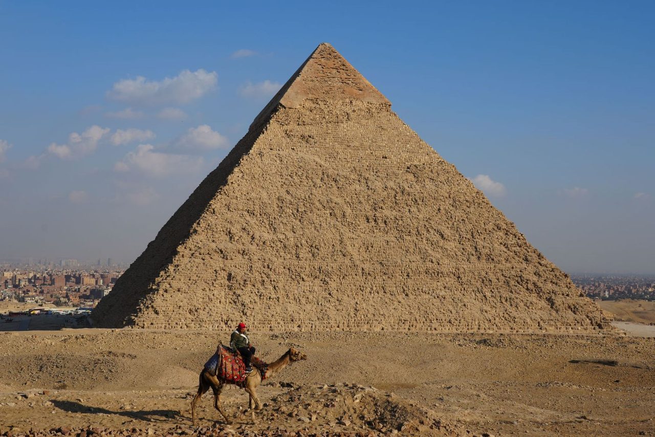 A lone rider passing by the magnificent Pyramid of Khafre