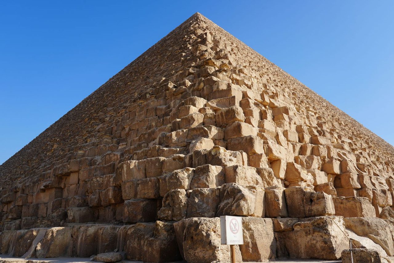 Looking up at the massive stone blocks of the Great Pyramid of Giza