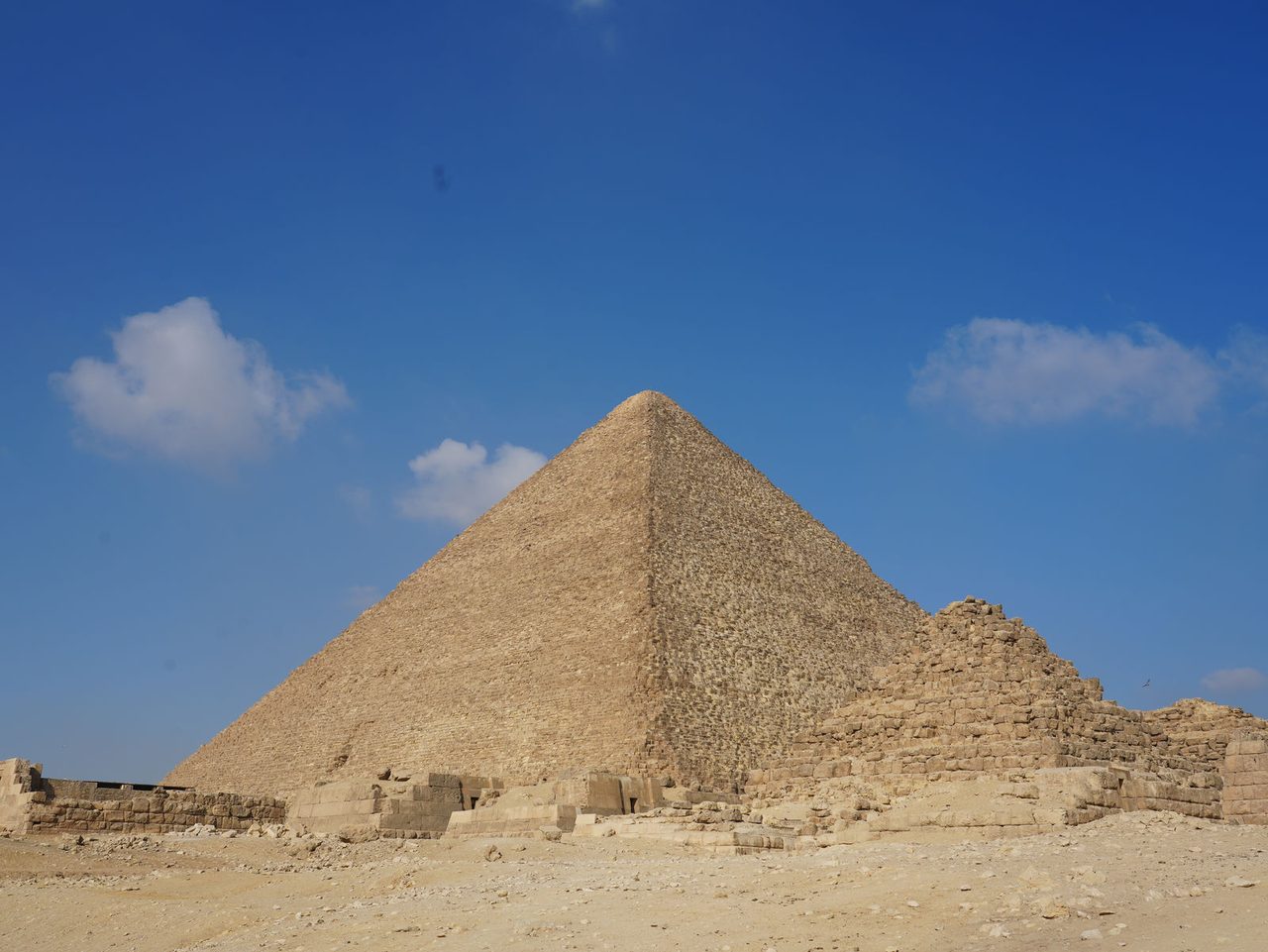 The Great Pyramid of Giza rising majestically against a deep blue sky