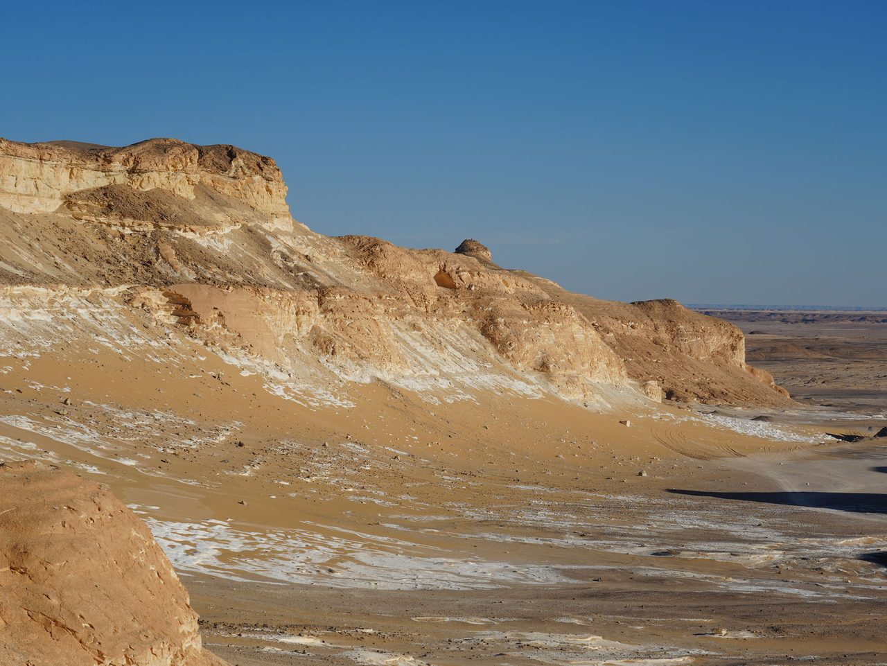 The majestic limestone cliffs of Agabat rising above the desert