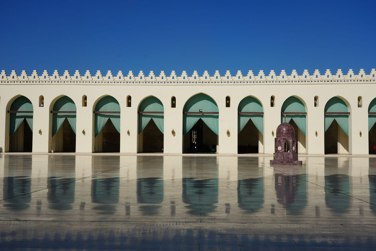 Perfect reflections on the marble courtyard of Al-Hakim Mosque