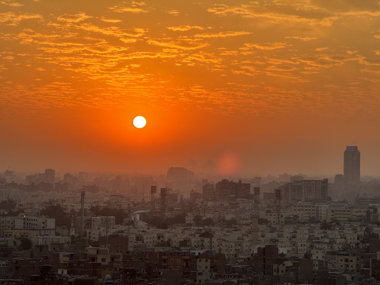 Sunset glow over the iconic Grand Nile Tower skyline