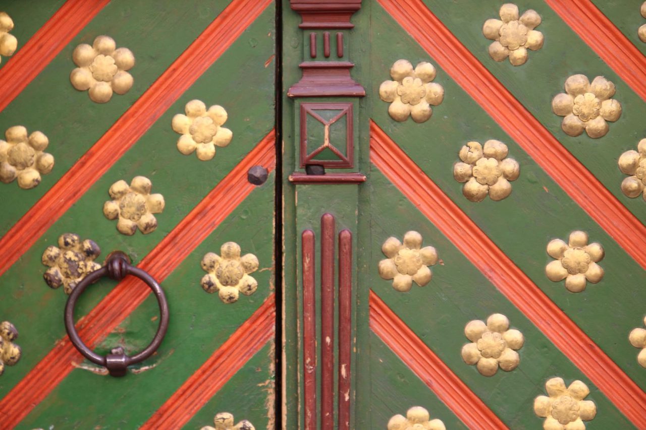 Beautiful ornaments on the green door
