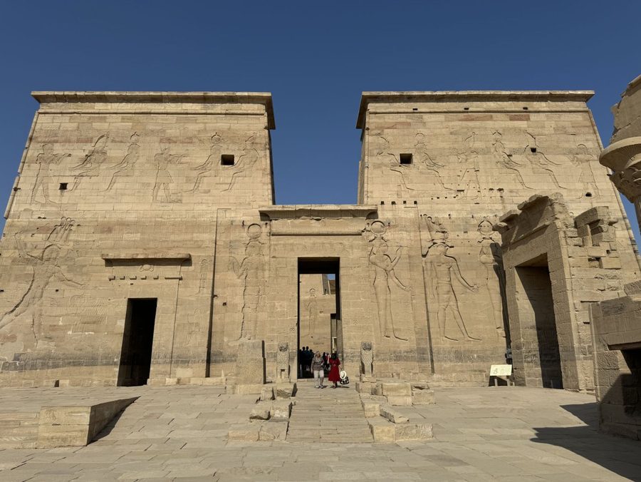 The grand first pylon of the historic Philae Temple rising into the blue sky