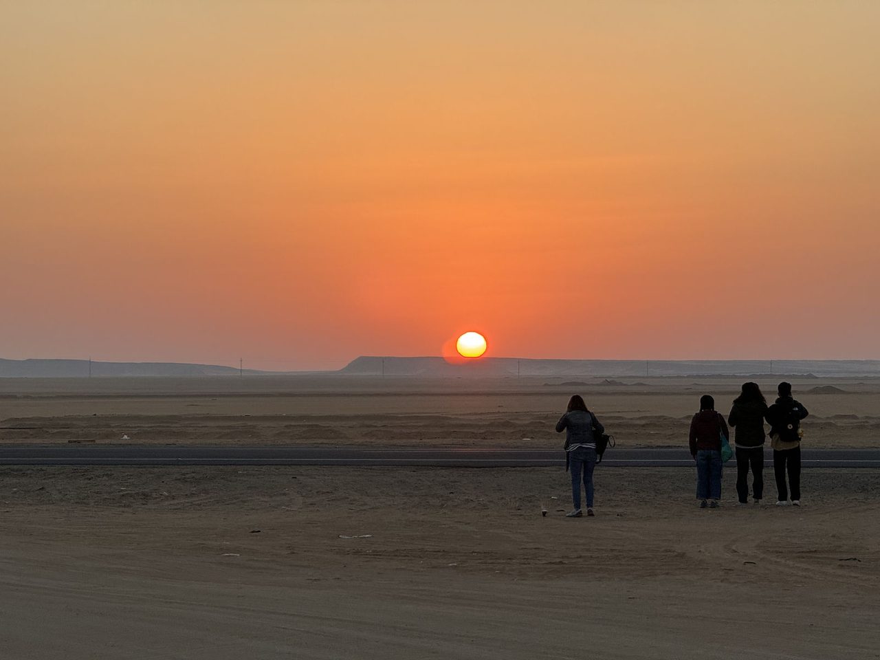 A blazing golden sunrise over the vast horizons of the Nubian Desert