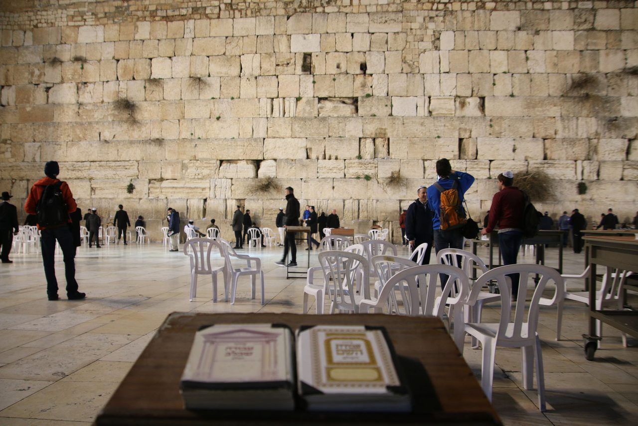 Prayer books looking toward The Western Wall