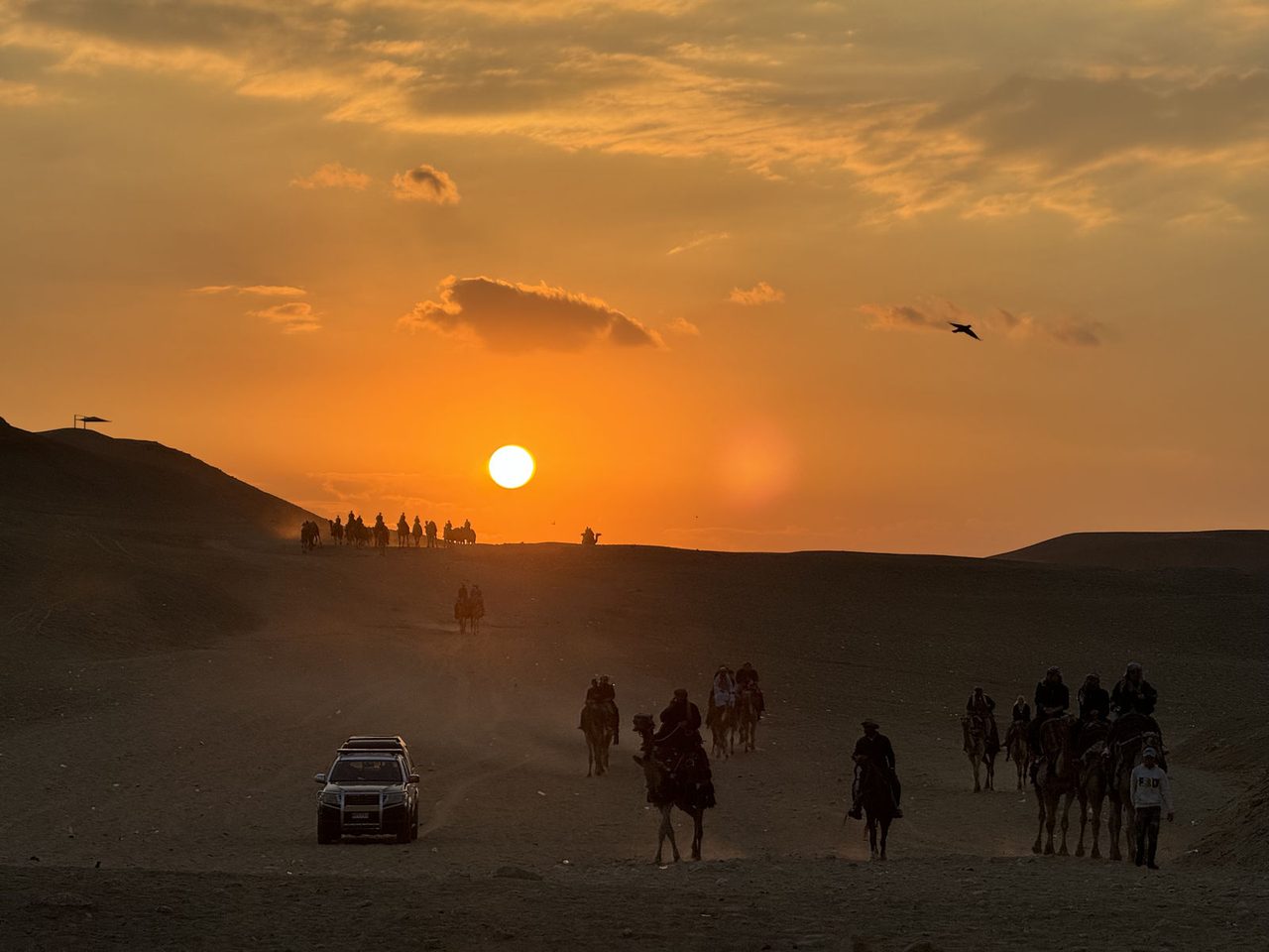 A bustling sunset caravan moving across the Giza Desert