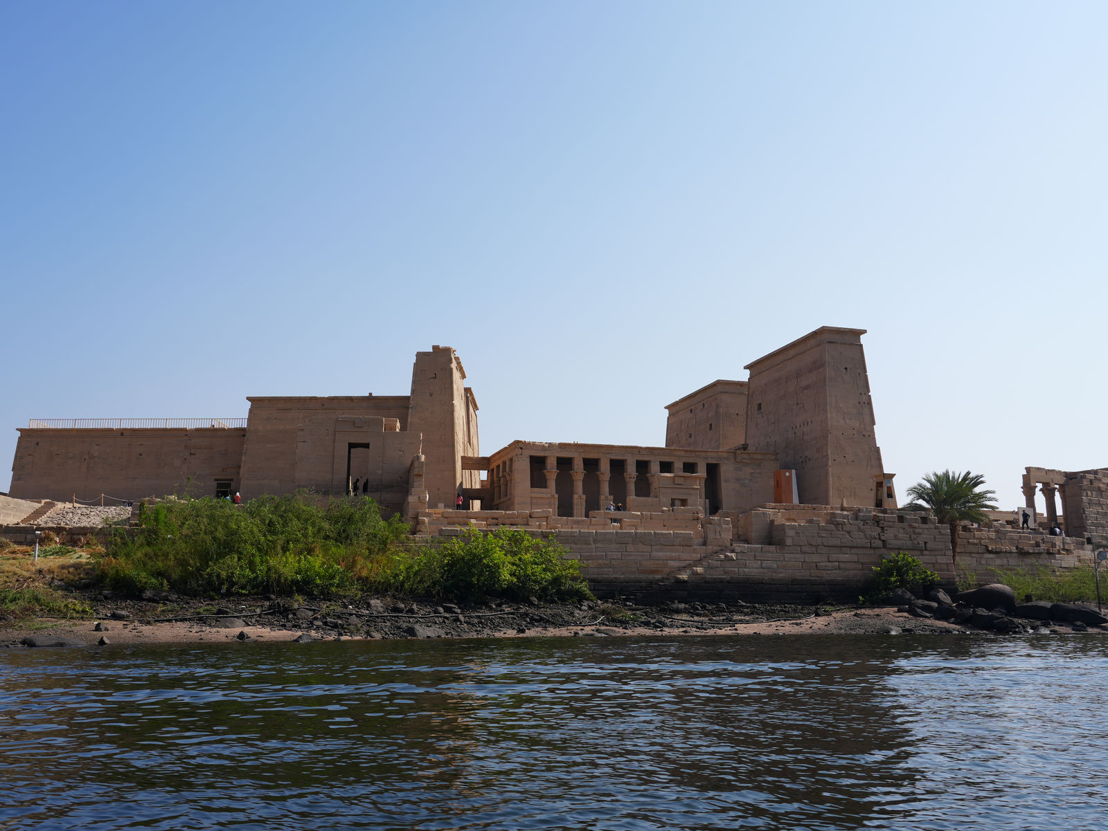 The majestic panorama of Philae Temple rising above the Nile River