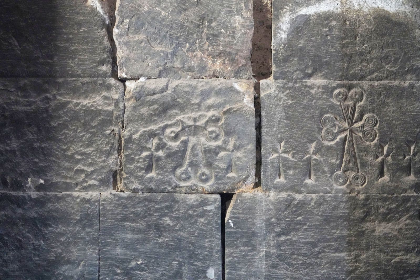 Ancient crosses carved into the stone wall