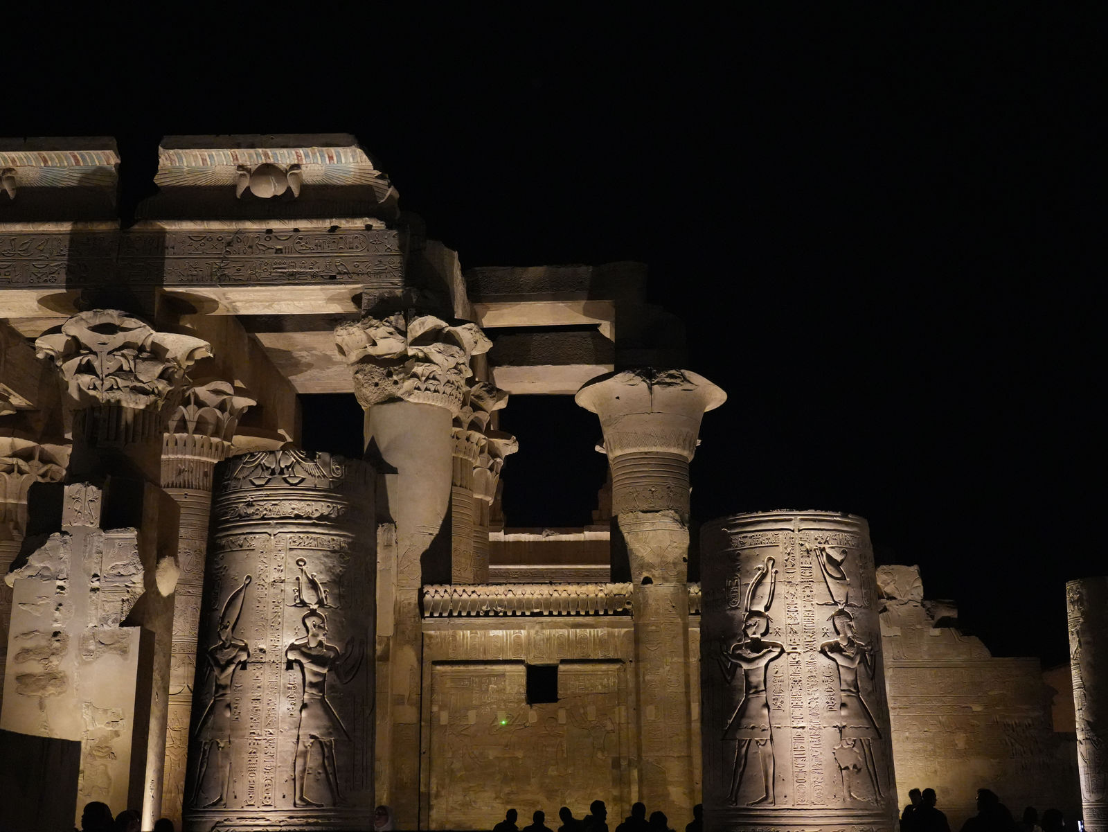 The majestic glowing columns of the Temple of Kom Ombo under the night sky