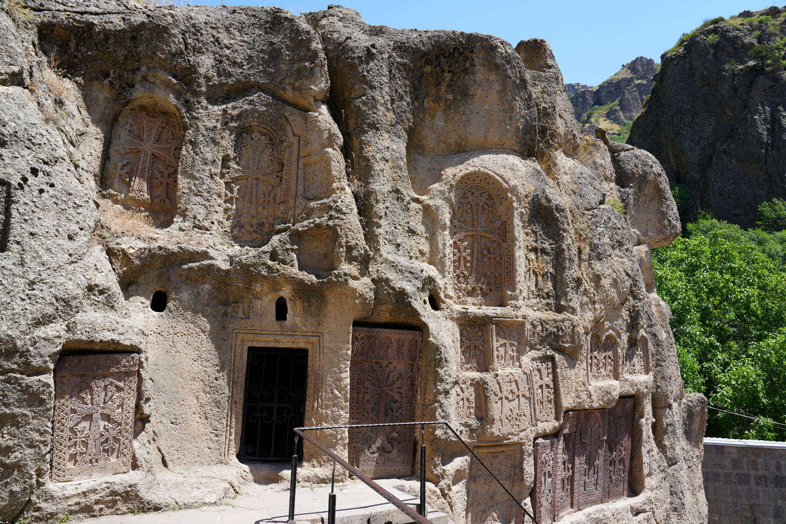 Ancient Khachkars (cross-stones) carved into the solid rock at Geghard