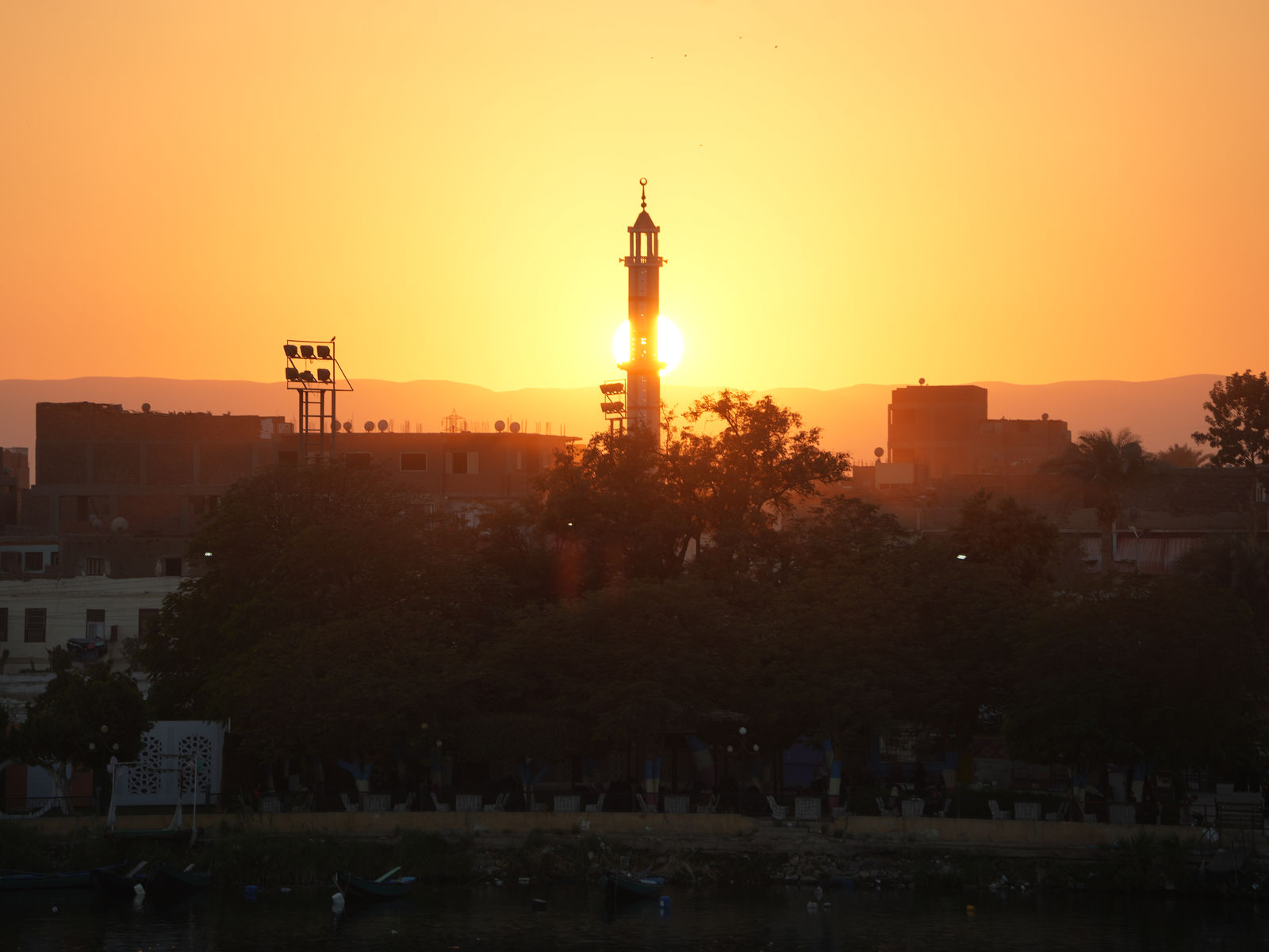The stunning silhouette of a historic minaret standing against the sunset glow