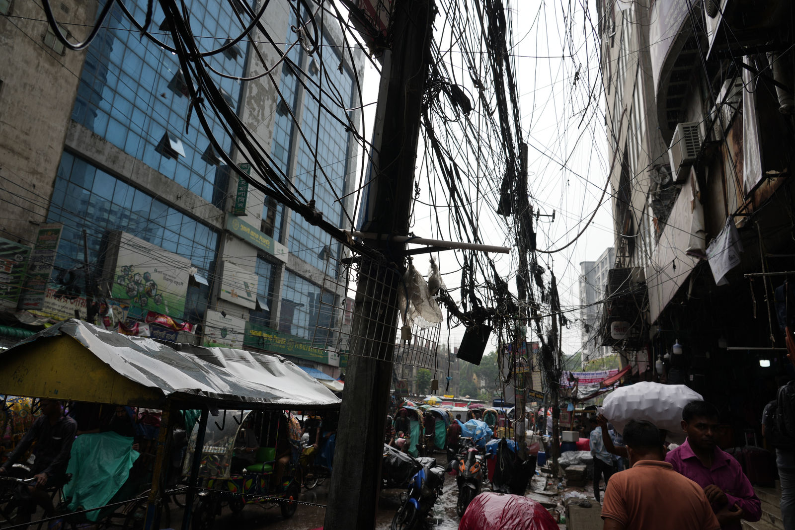 Tangled overhead power lines on a busy street