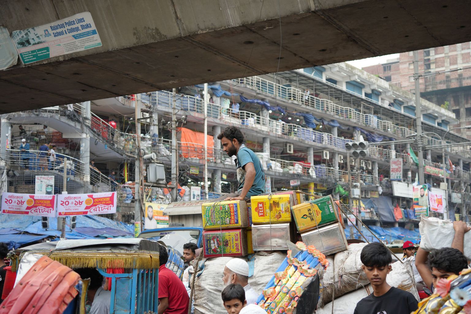 Street market scene under a flyover