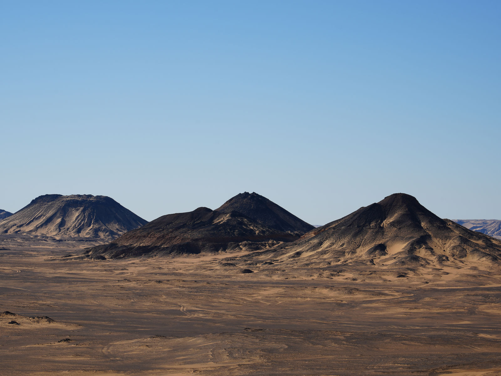 The volcanic volcanic hills rising across the Black Desert