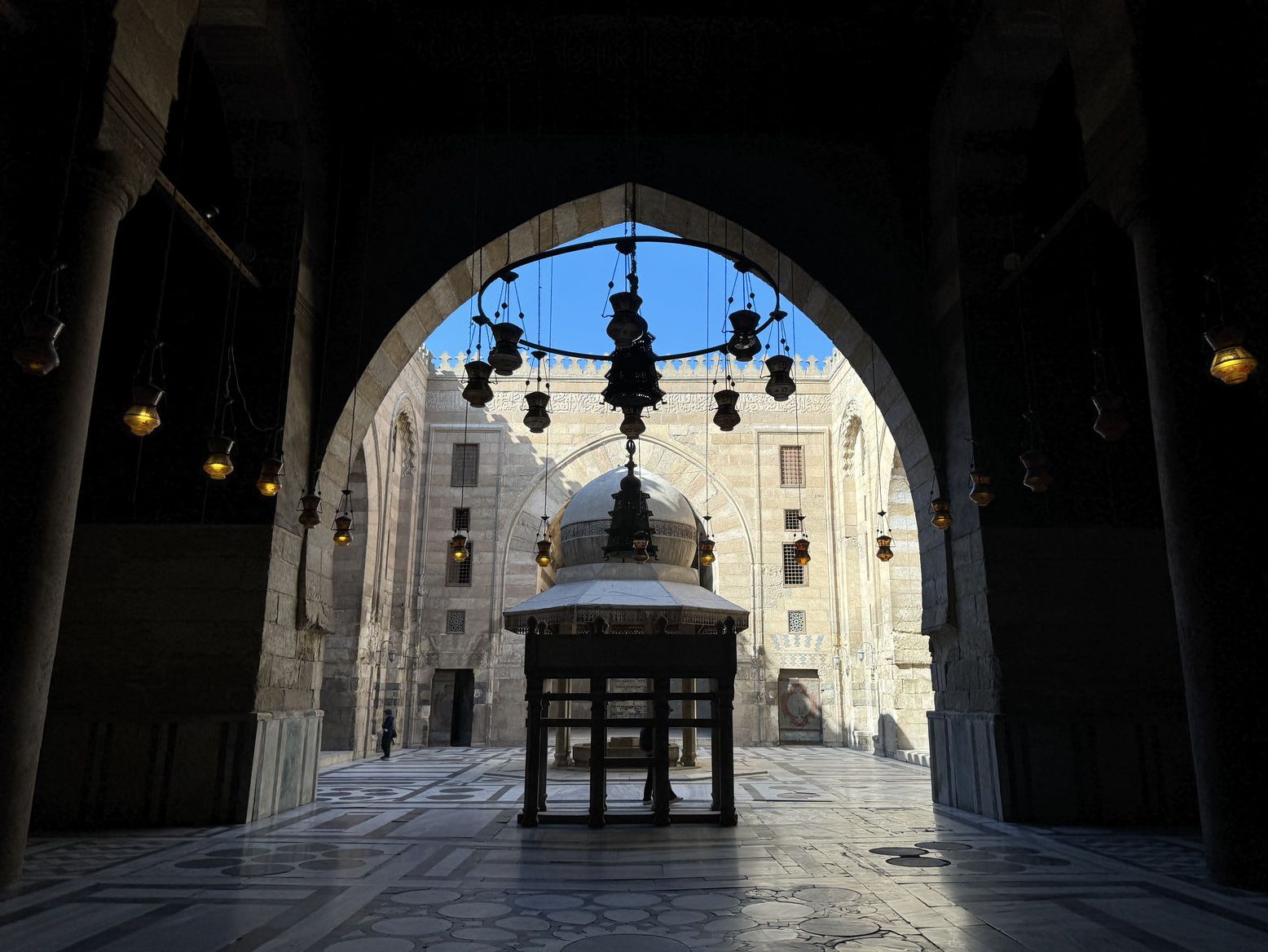 Looking out into the sunlit courtyard of Sultan Hassan Mosque