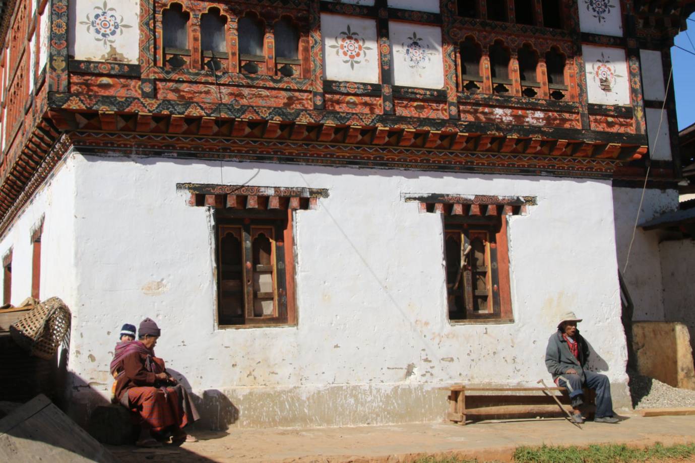 Local people sitting outside a traditional building
