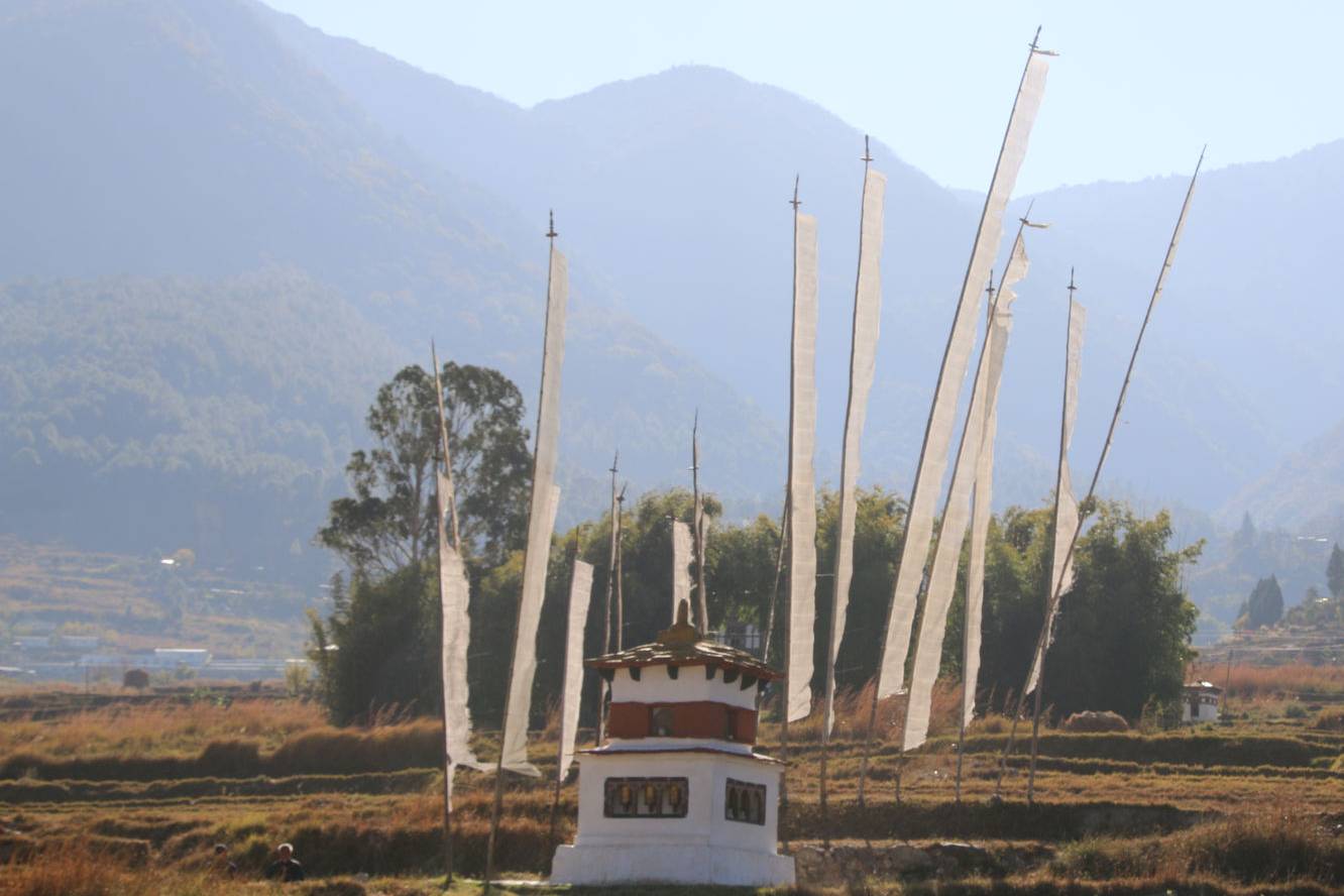 White prayer flags (Dhar) fluttering around a chorten