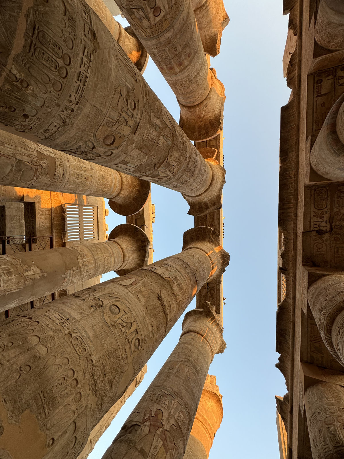 The soaring sandstone columns and carved hieroglyphs of the Great Hypostyle Hall at Karnak Temple
