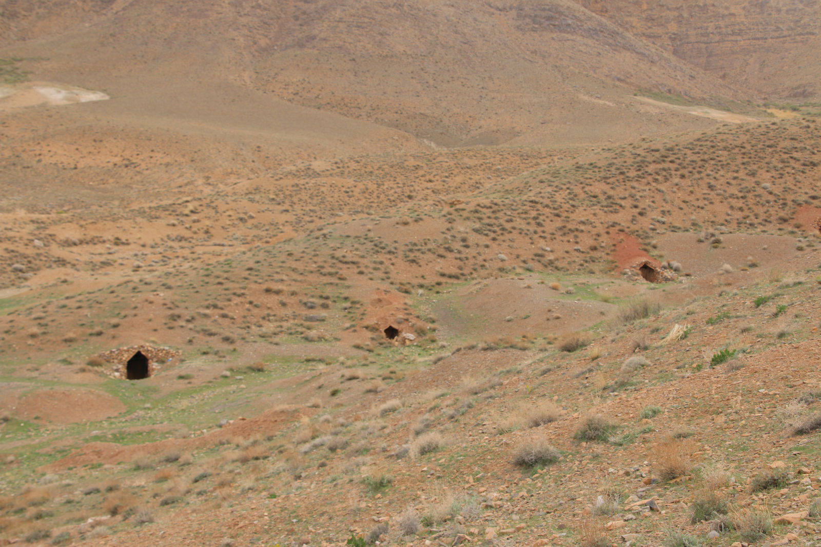 Traditional livestock shelters dug into the hillside